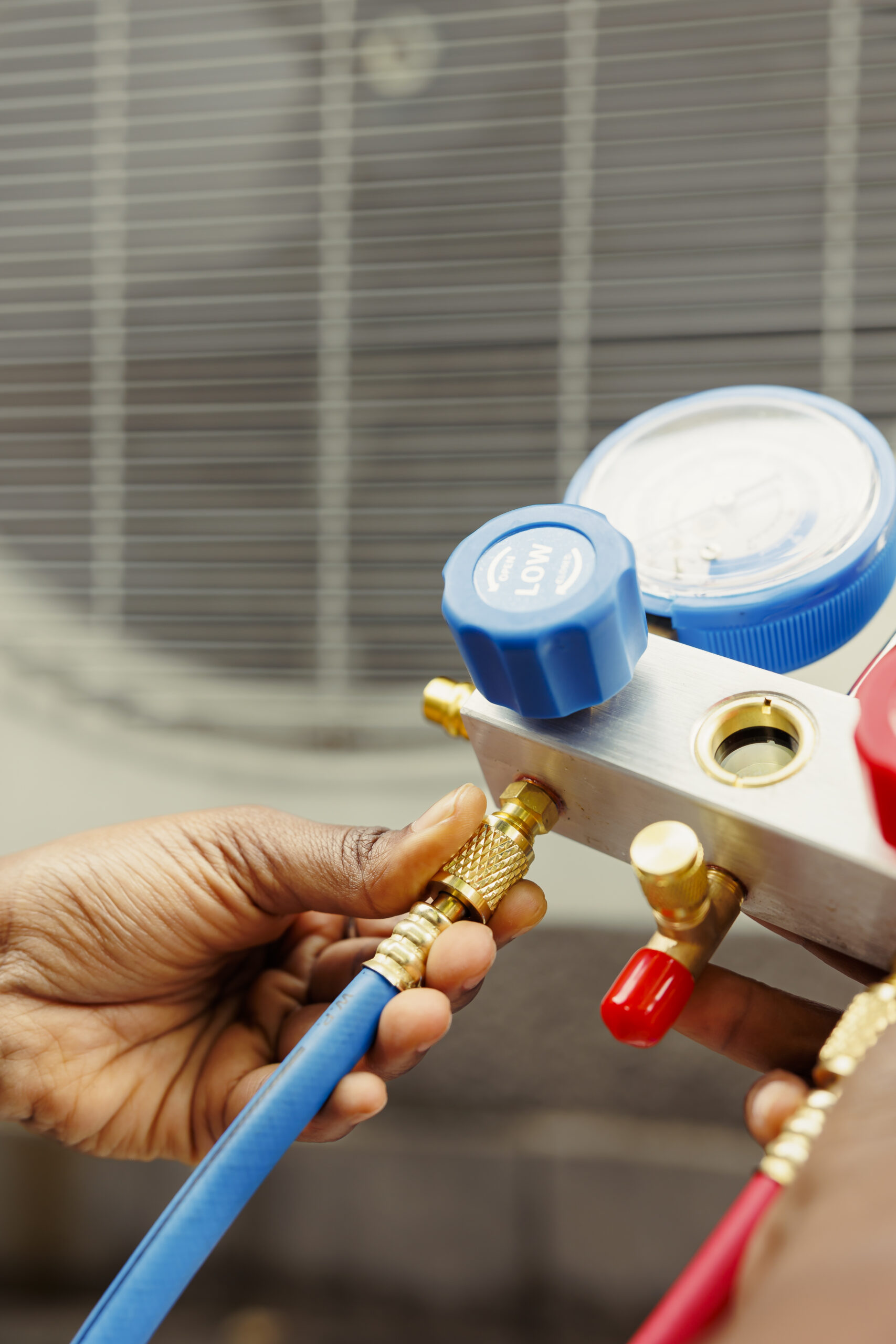 Climate Pro technician checking refrigerant levels on an AC unit